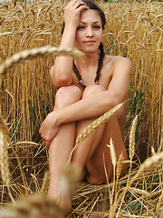 Sofi A shows off her large, natural breasts in a field